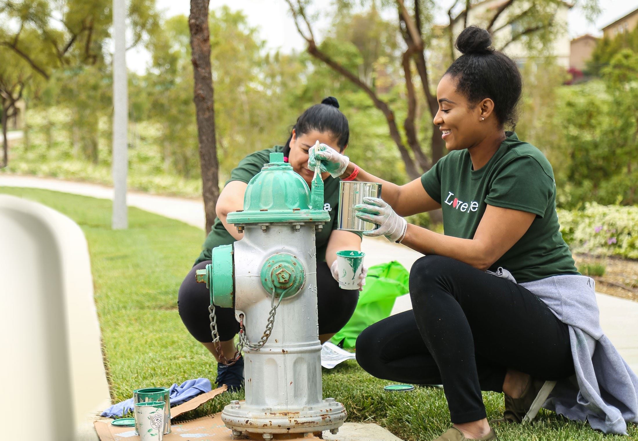 Women painting fire hydrant
