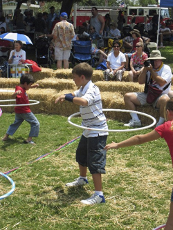 Young boy playing with a hula hoop